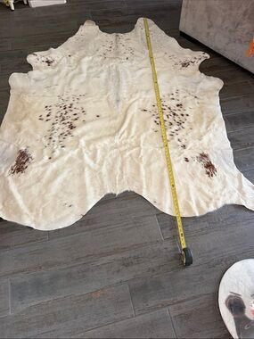 White and Brown Spotted Cowhide Rug - Premium Home Accent. Size is estimate.